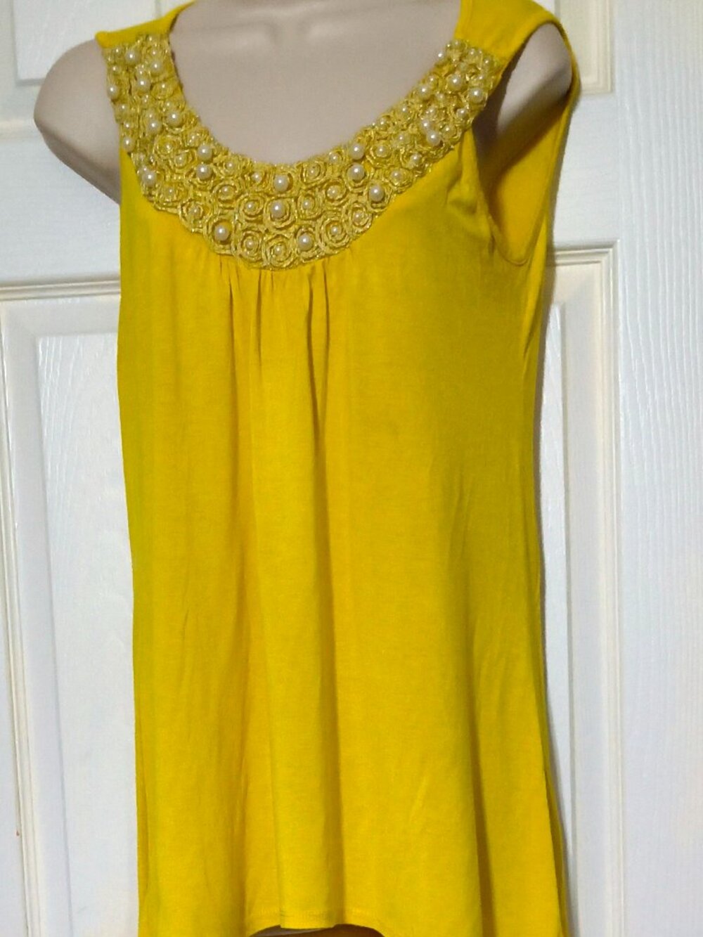 Yellow sleeveless top by Agenda.